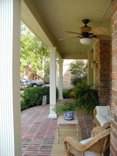 An open front porch that uses hardscapes and beautiful columns